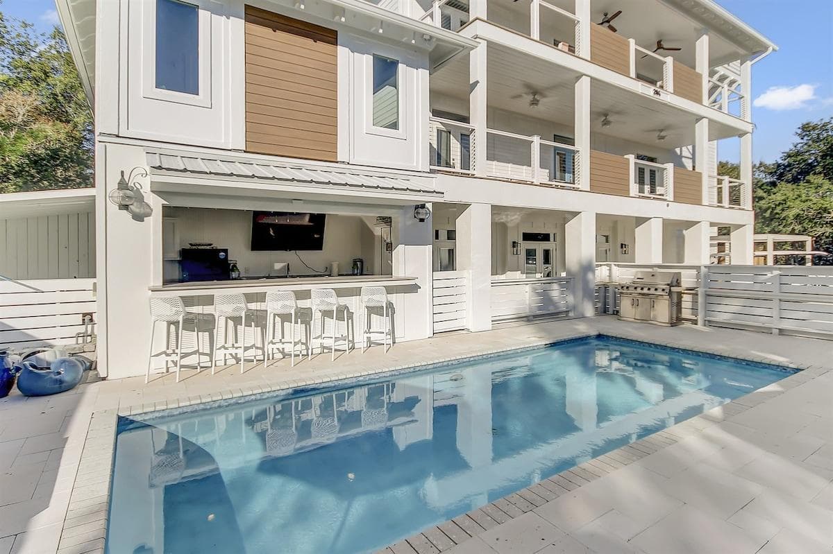 Poolside paradise at The Sandstone 30A! Enjoy sun-soaked days by your private pool and gather for al fresco entertainment at the outdoor cabana kitchen with a spacious TV. There are two margarita machines and a refrigerator for chilling your drinks!