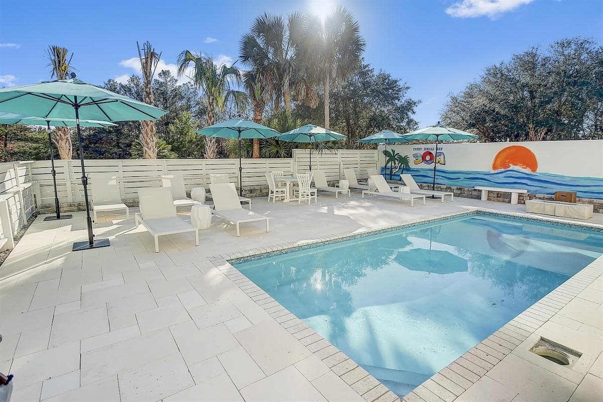 Dive into relaxation at The Sandstone 30A! Your private pool deck awaits—lounge in luxury under umbrellas or soak up the sun in style while enjoying the custom mural! There is a grill and a fire pit to enjoy during sunset!
